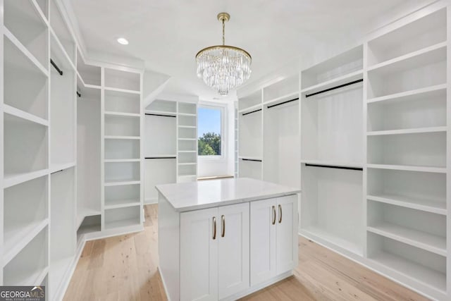 3205 Bold Springs Rd, Dacula, GA 30019 - walk in closet with light wood finished floors and a chandelier