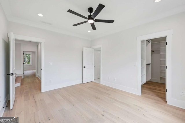 3205 Bold Springs Rd, Dacula, GA 30019 - unfurnished bedroom with light wood finished floors, a walk in closet, a closet, ceiling fan, and recessed lighting