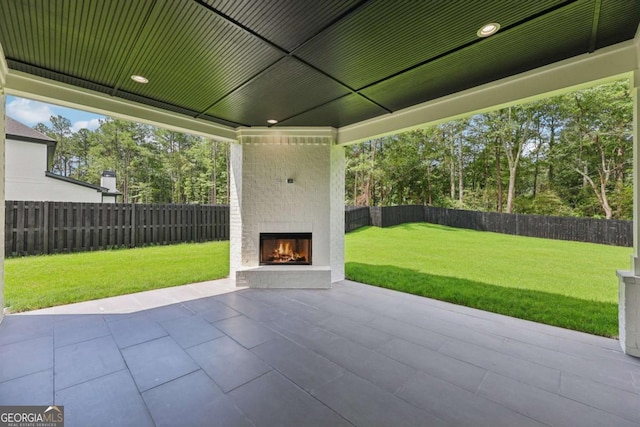 3205 Bold Springs Rd, Dacula, GA 30019 - fenced backyard featuring an outdoor brick fireplace and a patio