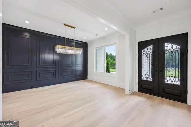 3205 Bold Springs Rd, Dacula, GA 30019 - foyer entrance with french doors, light wood-style floors, a decorative wall, a chandelier, and recessed lighting