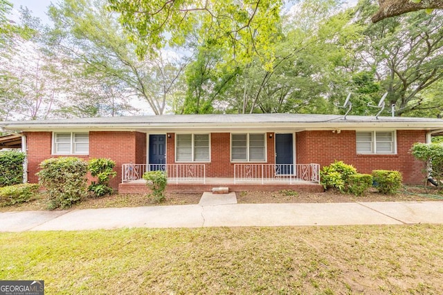 5952 Medlock Ave, Austell, GA 30106 - ranch-style house with covered porch, brick siding, and a front lawn