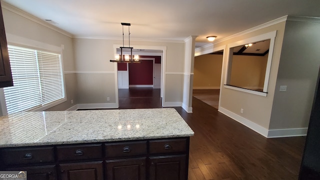 90 Alcovy Reserve Way, Covington, GA 30014 - kitchen featuring dark brown cabinetry, dark wood-style flooring, crown molding, light stone countertops, and a peninsula