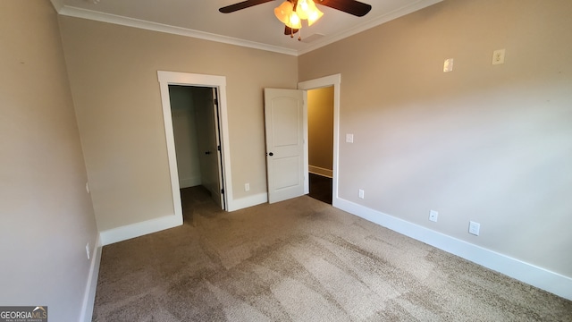 90 Alcovy Reserve Way, Covington, GA 30014 - unfurnished bedroom with a spacious closet, carpet, ornamental molding, a ceiling fan, and a closet