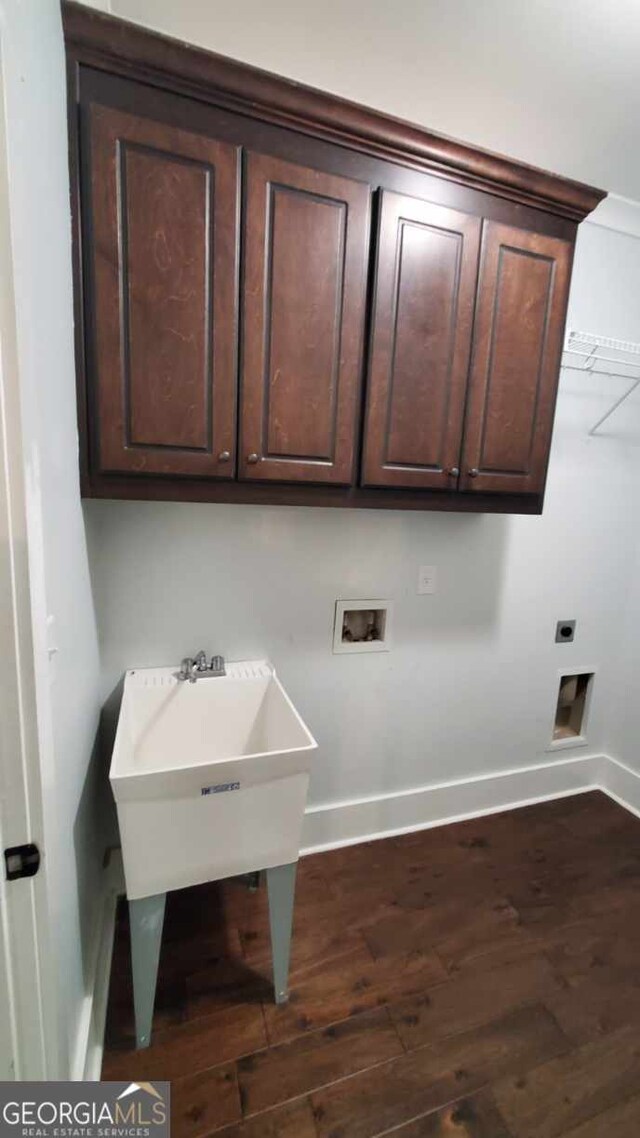 90 Alcovy Reserve Way, Covington, GA 30014 - washroom featuring dark wood-style flooring, washer hookup, cabinet space, and hookup for an electric dryer