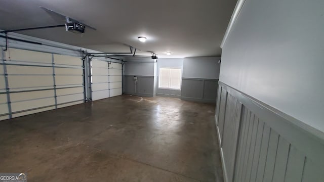 90 Alcovy Reserve Way, Covington, GA 30014 - garage with a garage door opener, wainscoting, and a decorative wall