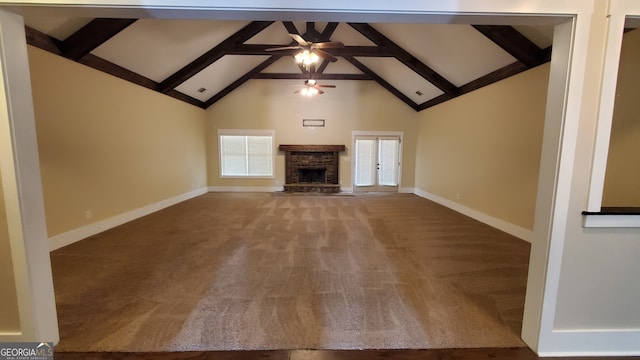 90 Alcovy Reserve Way, Covington, GA 30014 - unfurnished living room featuring carpet, a ceiling fan, beam ceiling, high vaulted ceiling, and a fireplace with raised hearth
