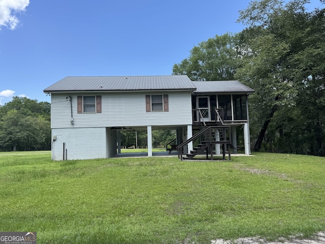 42 Lagoon Rd, Statesboro, GA 30461 - back of house featuring a sunroom, a metal roof, a carport, a yard, and stairs