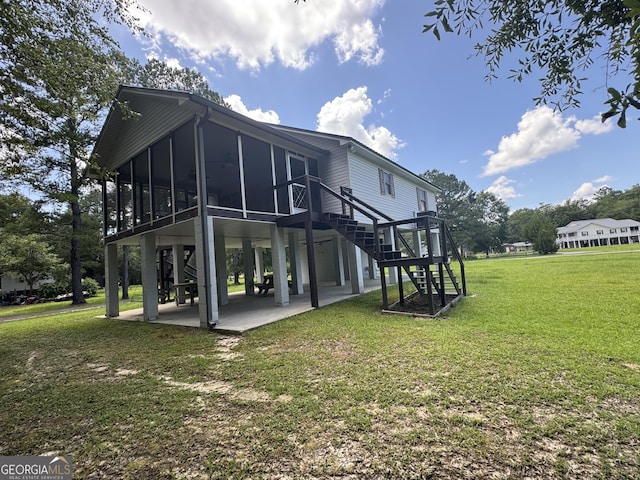 42 Lagoon Rd, Statesboro, GA 30461 - rear view of house featuring a sunroom, a patio, stairway, and a lawn