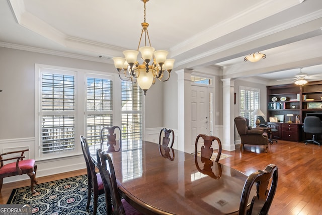 220 Begonia Ct, Griffin, GA 30223 - dining room with ornate columns, crown molding, wood finished floors, a chandelier, and a wainscoted wall