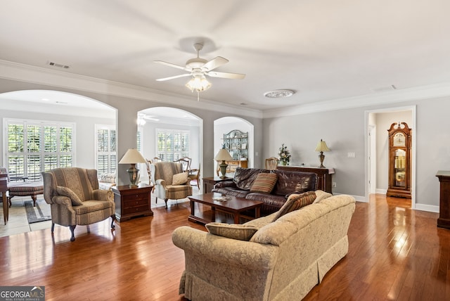 220 Begonia Ct, Griffin, GA 30223 - living room featuring arched walkways, a ceiling fan, wood-type flooring, and ornamental molding