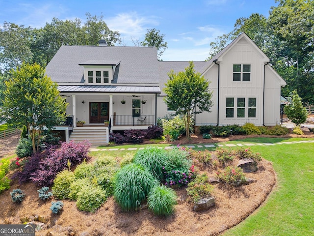 4813 Jess Helton Rd, Gainesville, GA 30506 - modern farmhouse style home featuring a standing seam roof, a front lawn, a metal roof, board and batten siding, and roof with shingles
