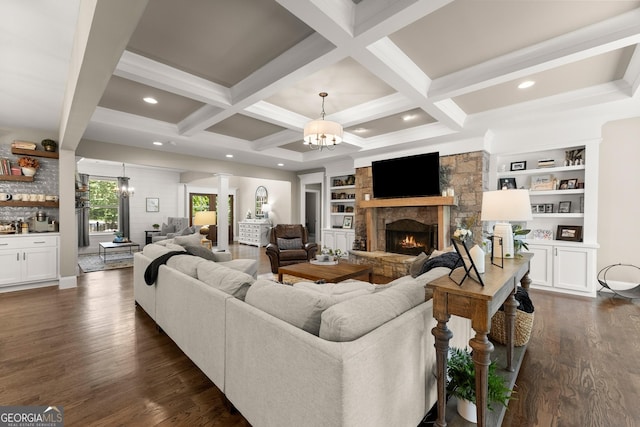 4813 Jess Helton Rd, Gainesville, GA 30506 - living area with a chandelier, dark wood-style flooring, a stone fireplace, beam ceiling, and decorative columns