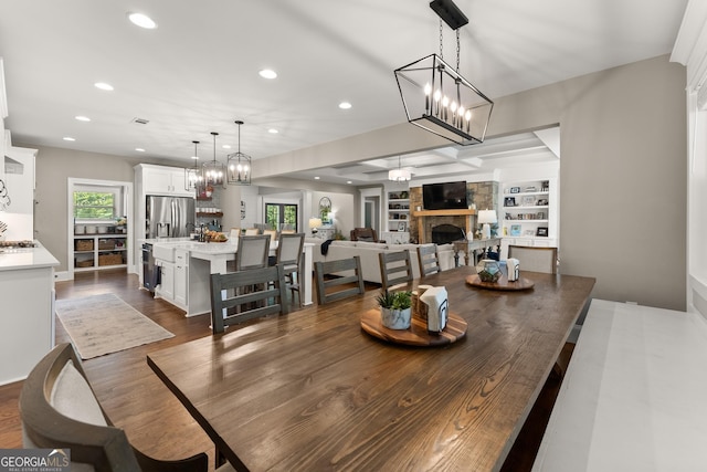 4813 Jess Helton Rd, Gainesville, GA 30506 - dining space featuring recessed lighting, a chandelier, a stone fireplace, and dark wood finished floors