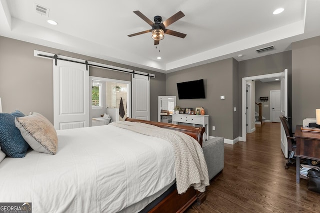 4813 Jess Helton Rd, Gainesville, GA 30506 - bedroom with a tray ceiling, a barn door, recessed lighting, dark wood-type flooring, and ceiling fan