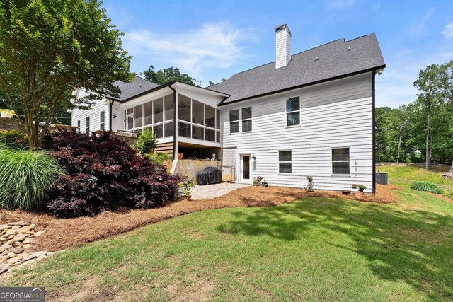 4813 Jess Helton Rd, Gainesville, GA 30506 - rear view of property with a sunroom, a chimney, a lawn, roof with shingles, and a patio area