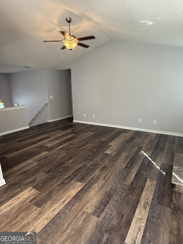 330 Anchors Way, Winder, GA 30680 - unfurnished living room with a ceiling fan, vaulted ceiling, wood finished floors, and a textured ceiling