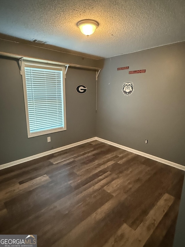 330 Anchors Way, Winder, GA 30680 - spare room with a textured ceiling and dark wood-type flooring