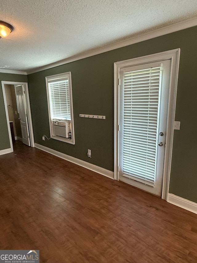 330 Anchors Way, Winder, GA 30680 - spare room with ornamental molding, a textured ceiling, dark wood-type flooring, and cooling unit