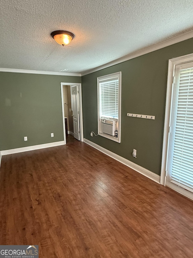 330 Anchors Way, Winder, GA 30680 - unfurnished bedroom featuring crown molding, a textured ceiling, dark wood finished floors, and cooling unit