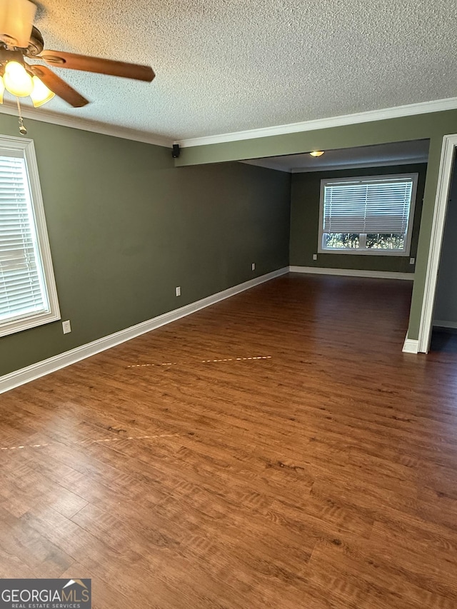 330 Anchors Way, Winder, GA 30680 - spare room with a textured ceiling, ornamental molding, ceiling fan, and wood finished floors
