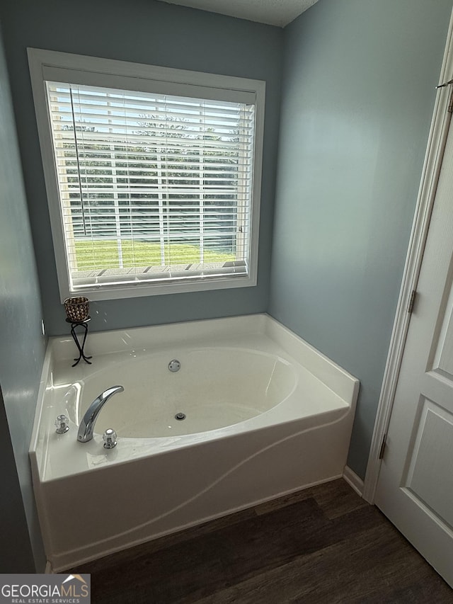 330 Anchors Way, Winder, GA 30680 - full bathroom with a garden tub and wood finished floors
