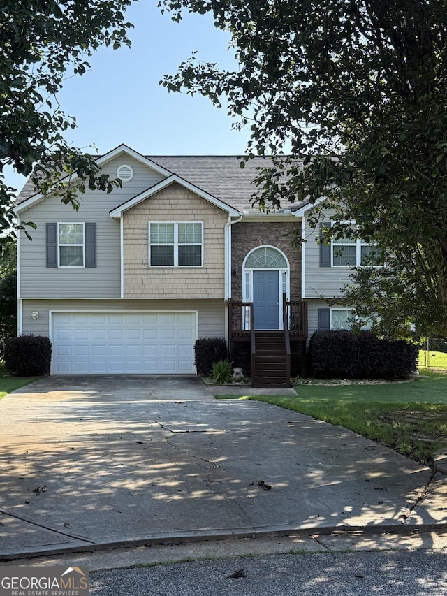 330 Anchors Way, Winder, GA 30680 - split foyer home with an attached garage, driveway, and stone siding