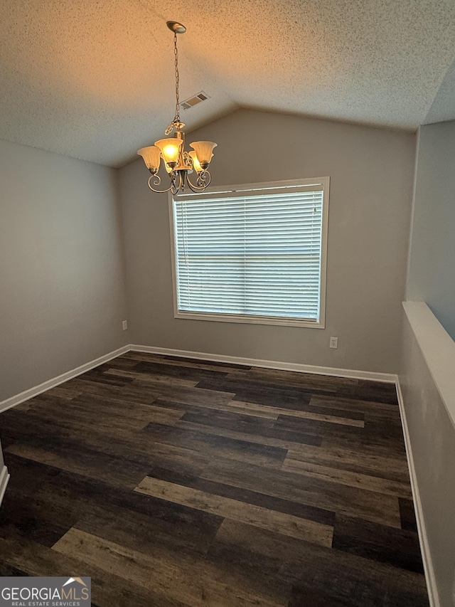 330 Anchors Way, Winder, GA 30680 - spare room featuring a chandelier, a textured ceiling, dark wood-style flooring, and lofted ceiling