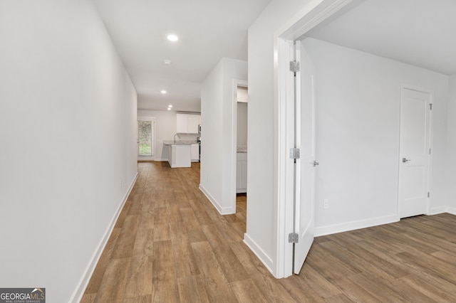 1184 Bluecoat Cir Unit 84, Hampton, GA 30228 - hallway with light wood finished floors and recessed lighting