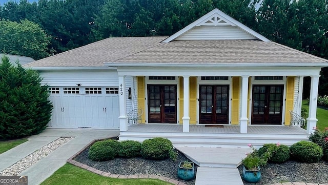 420 Ashbury Cir, Dallas, GA 30157 - view of front of home featuring french doors, a shingled roof, covered porch, a garage, and driveway