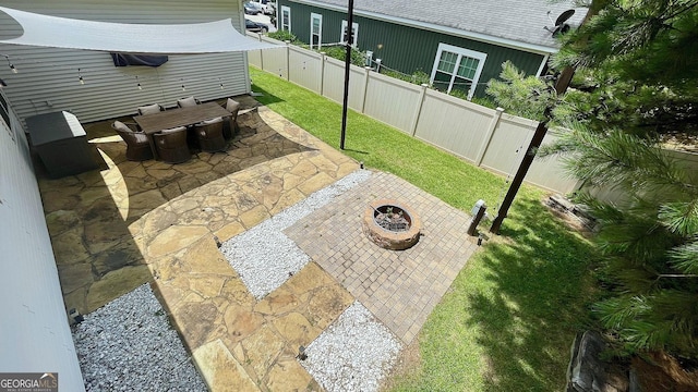 420 Ashbury Cir, Dallas, GA 30157 - fenced backyard with a fire pit, a patio, and outdoor dining space