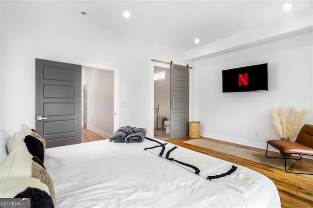 167 Sampson St, Atlanta, GA 30312 - bedroom with a barn door, wood finished floors, recessed lighting, and ensuite bath