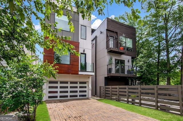 167 Sampson St, Atlanta, GA 30312 - view of front facade with decorative driveway, a garage, and a balcony