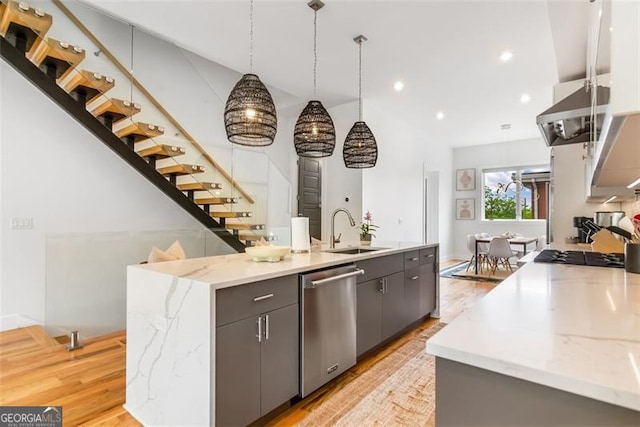 167 Sampson St, Atlanta, GA 30312 - kitchen with stainless steel dishwasher, a center island with sink, light wood-style flooring, light stone countertops, and recessed lighting