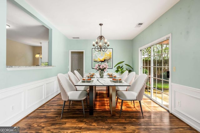 5035 Foxberry Ln, Roswell, GA 30075 - dining room featuring a chandelier, wood finished floors, a wainscoted wall, and a decorative wall