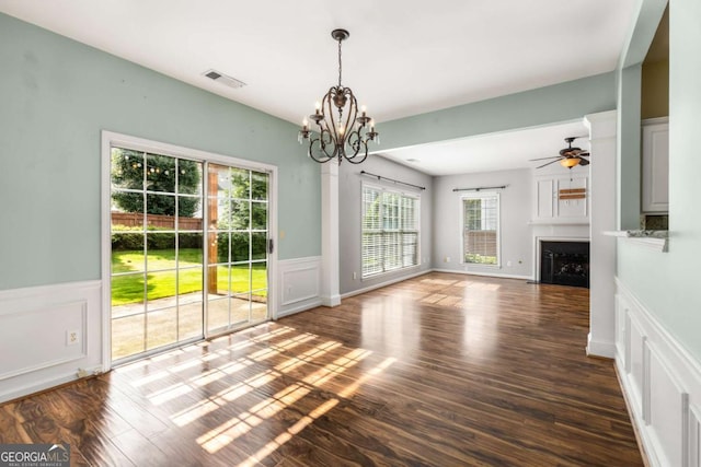 5035 Foxberry Ln, Roswell, GA 30075 - unfurnished dining area with a chandelier, a fireplace, wood finished floors, a decorative wall, and wainscoting