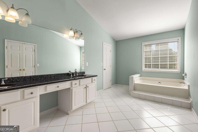 5035 Foxberry Ln, Roswell, GA 30075 - full bathroom with double vanity, vaulted ceiling, a bath, and tile patterned floors