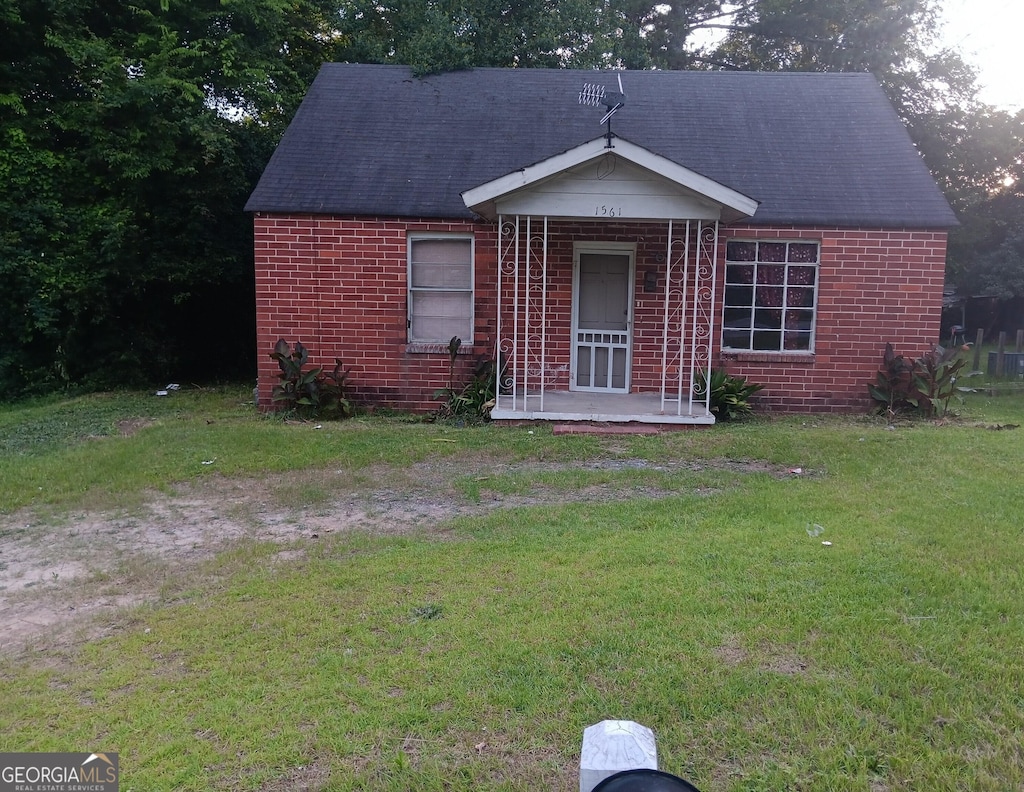1561 Dexter Ave, Macon, GA 31204 - view of front facade with brick siding, a front lawn, and roof with shingles
