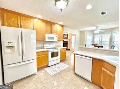 121 Pinnacle Ln, Mcdonough, GA 30253 - kitchen with white appliances, ceiling fan, recessed lighting, light countertops, and a textured ceiling