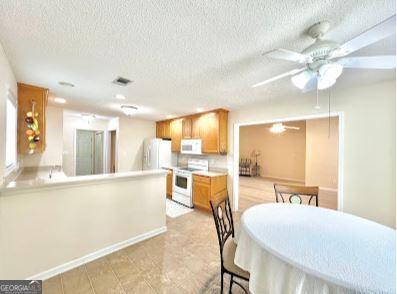 121 Pinnacle Ln, Mcdonough, GA 30253 - dining room with ceiling fan and a textured ceiling