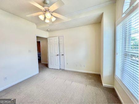 121 Pinnacle Ln, Mcdonough, GA 30253 - unfurnished bedroom featuring carpet, a closet, and ceiling fan