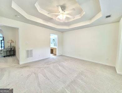 121 Pinnacle Ln, Mcdonough, GA 30253 - carpeted empty room with a tray ceiling and ceiling fan