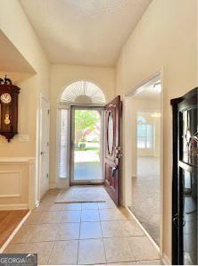 121 Pinnacle Ln, Mcdonough, GA 30253 - foyer entrance with plenty of natural light, light tile patterned floors, and vaulted ceiling