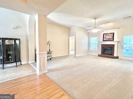 121 Pinnacle Ln, Mcdonough, GA 30253 - unfurnished living room with a glass covered fireplace, ceiling fan, and carpet