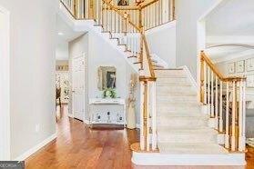 380 Victorian Ln, Duluth, GA 30097 - staircase featuring a high ceiling and wood finished floors