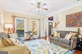 380 Victorian Ln, Duluth, GA 30097 - living area with crown molding, ceiling fan, wood finished floors, and stairway