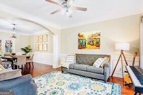 380 Victorian Ln, Duluth, GA 30097 - living area featuring arched walkways, a ceiling fan, ornamental molding, and wood finished floors
