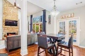 380 Victorian Ln, Duluth, GA 30097 - dining room with dark wood-type flooring and a fireplace