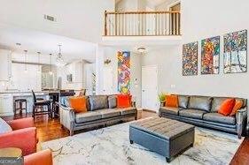 380 Victorian Ln, Duluth, GA 30097 - living room featuring a towering ceiling, plenty of natural light, and wood finished floors