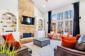 380 Victorian Ln, Duluth, GA 30097 - living room with a fireplace, built in features, high vaulted ceiling, and recessed lighting