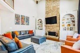 380 Victorian Ln, Duluth, GA 30097 - living room featuring a high ceiling and a stone fireplace